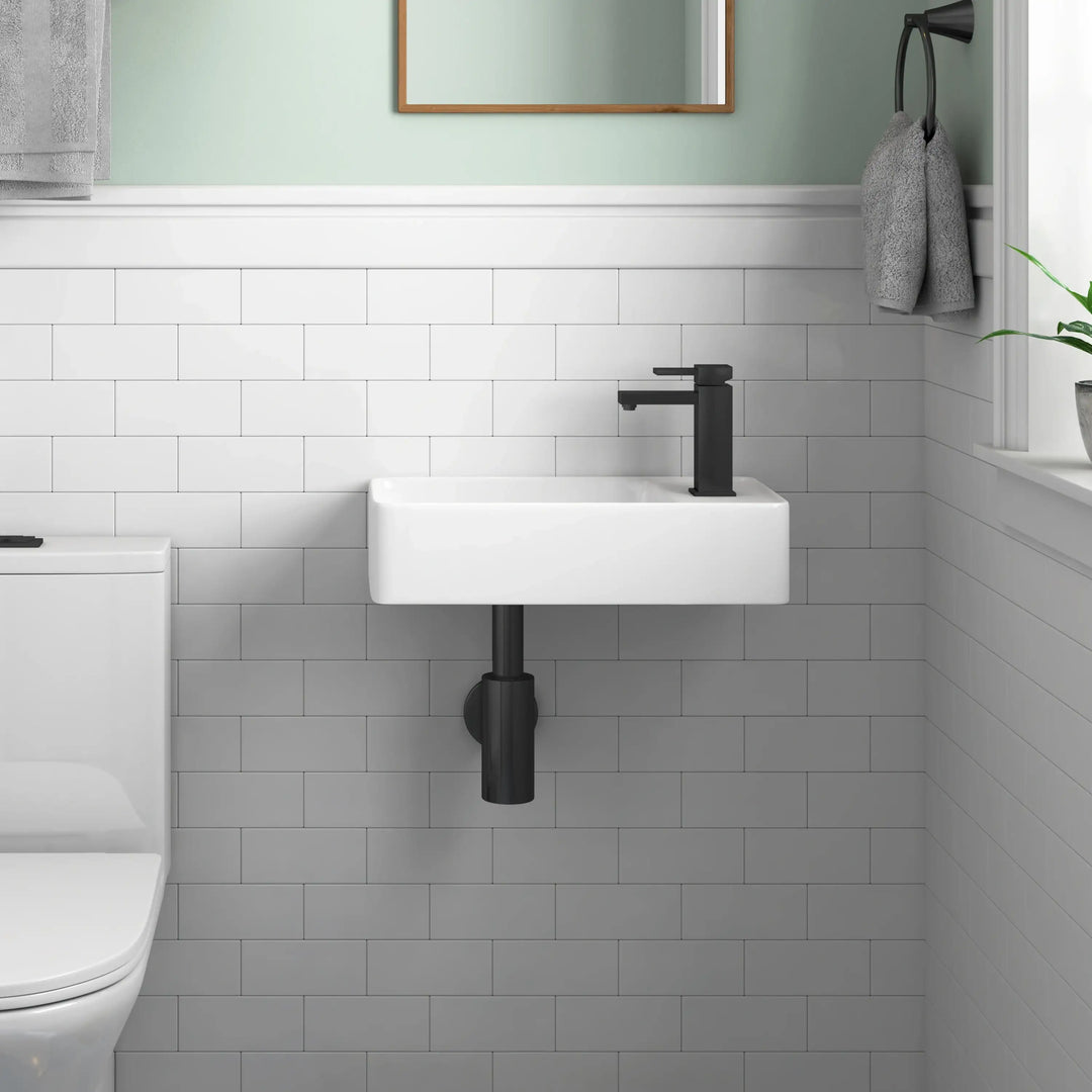 Wall-mounted white ceramic sink with matte black faucet