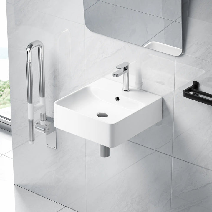 White wall-mounted square sink with chrome faucet.