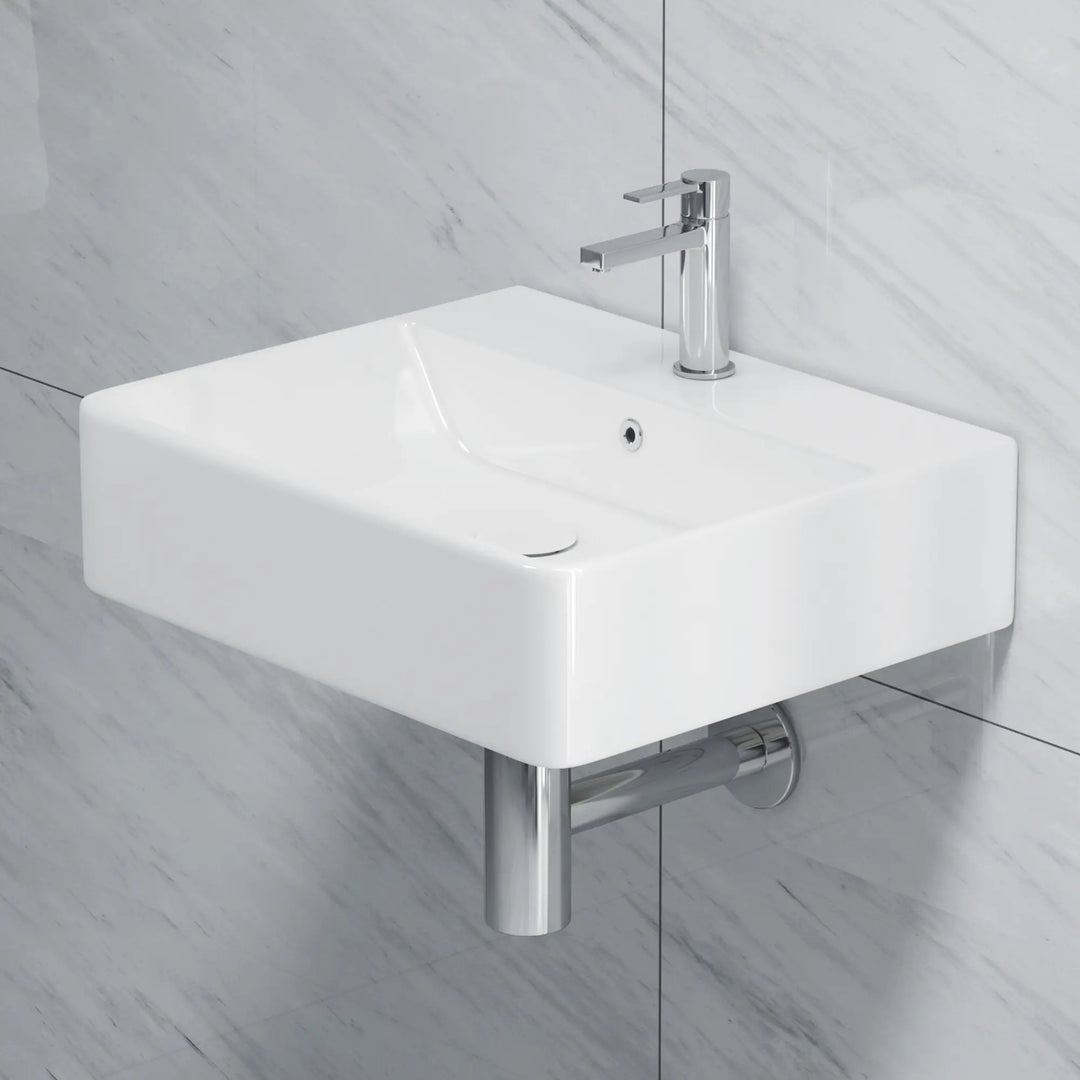 White rectangular ceramic sink with chrome faucet and drain.