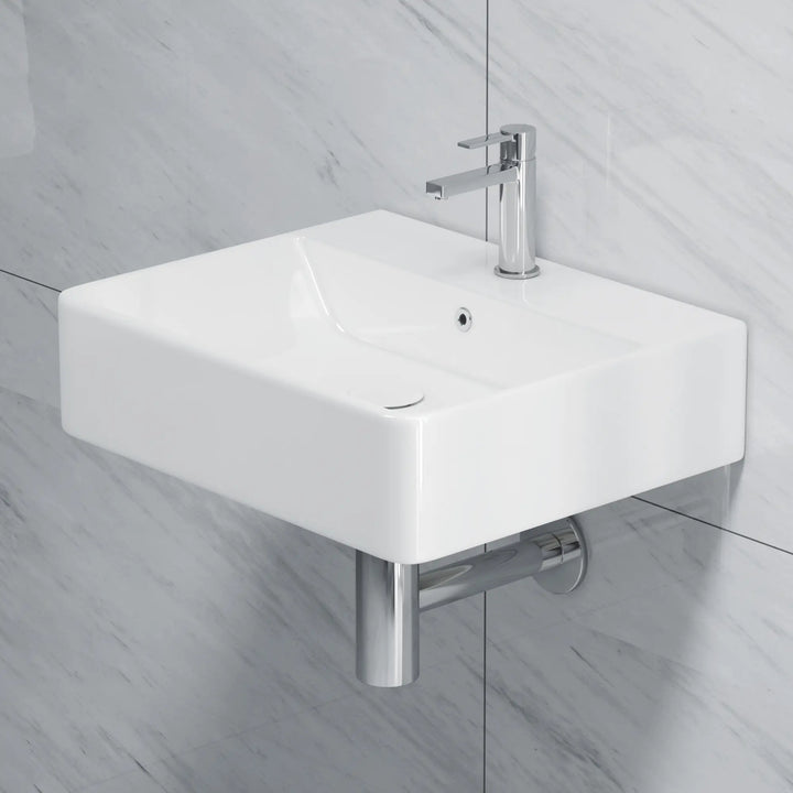 White rectangular ceramic sink with chrome faucet and drain.