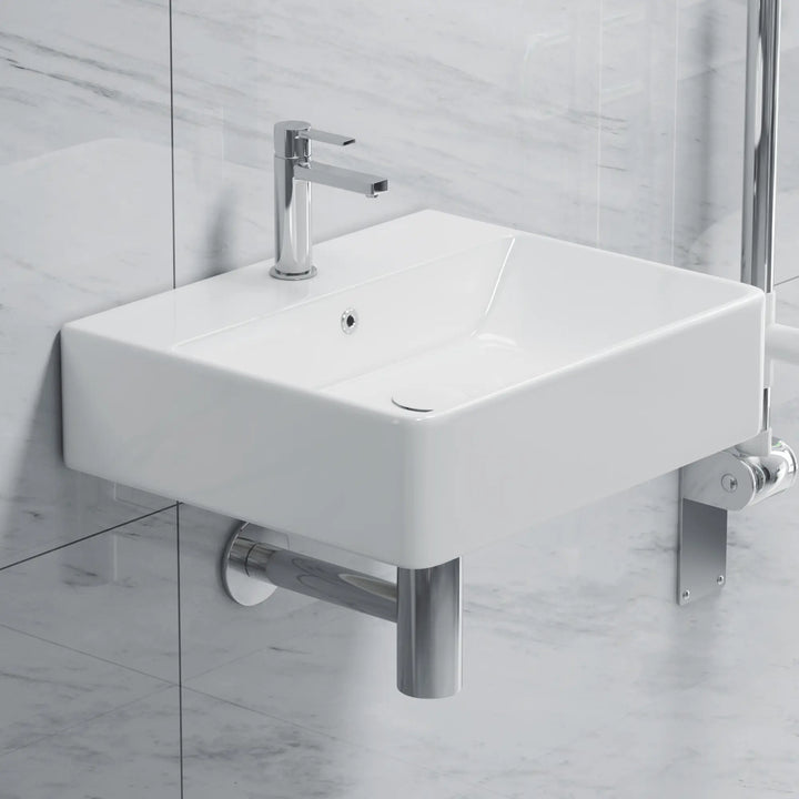White rectangular ceramic sink with chrome faucet and drain.