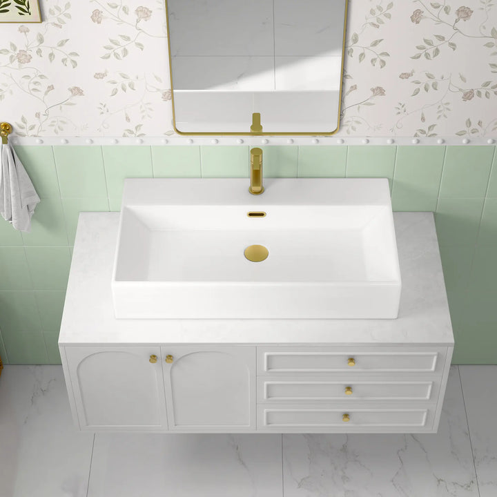 White ceramic single-hole sink with dimension markings.