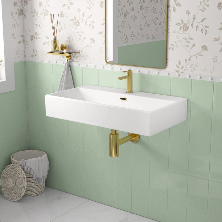 White ceramic single-hole sink with dimension markings.