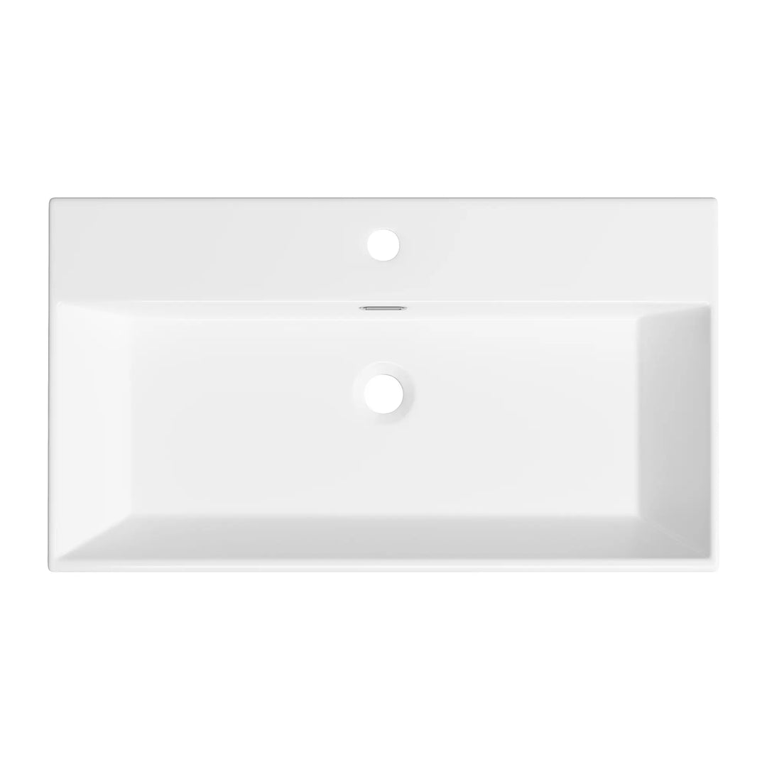 Top view of white rectangular sink with faucet and overflow holes