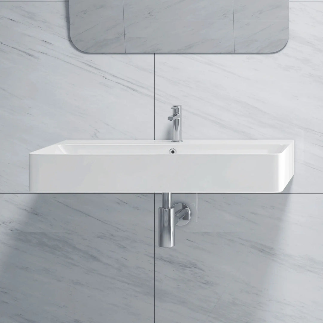 Wall-mounted white ceramic bathroom sink with integrated basin and single-handle faucet