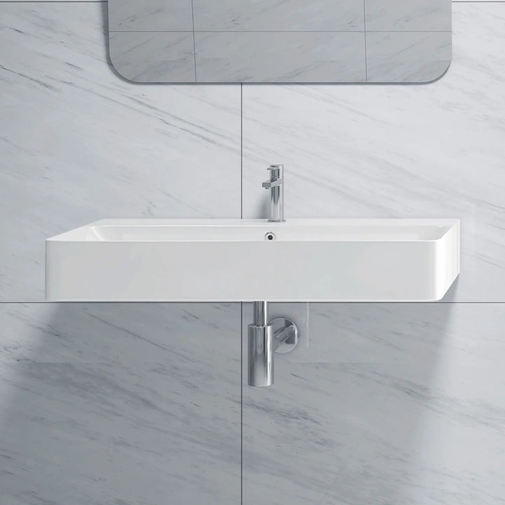 Wall-mounted white ceramic bathroom sink with integrated basin and single-handle faucet