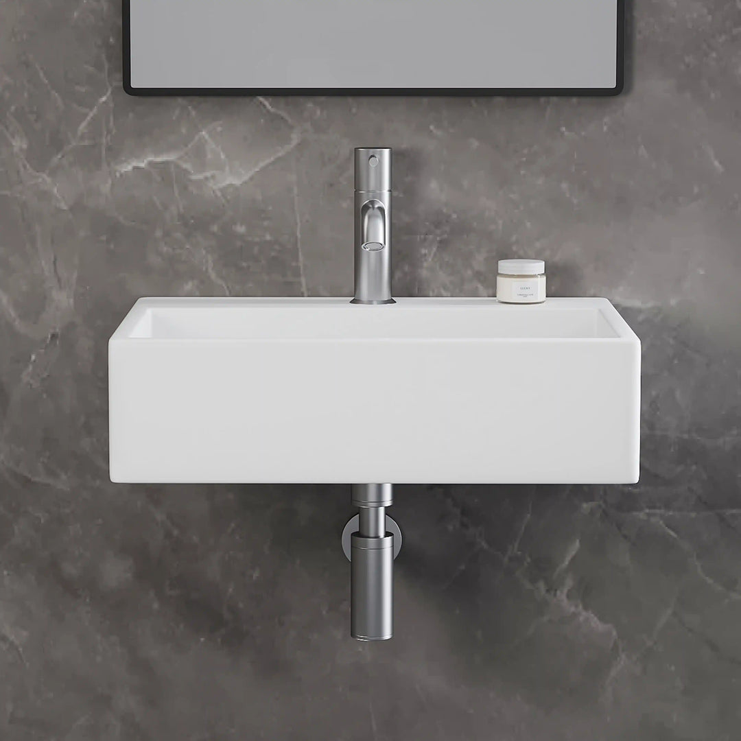 White rectangular wall-mounted solid surface bathroom sink with brushed nickel faucet