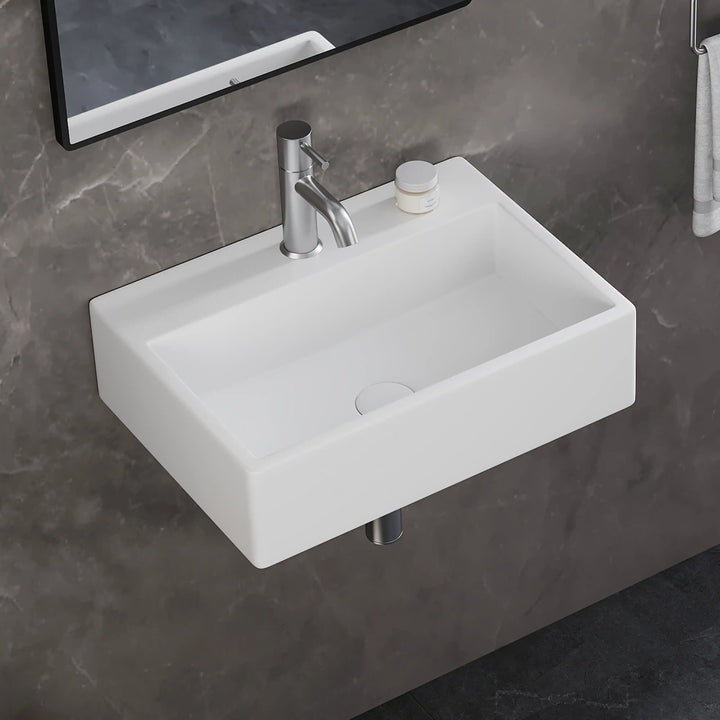 White rectangular wall-mounted ceramic sink with silver bathroom faucet