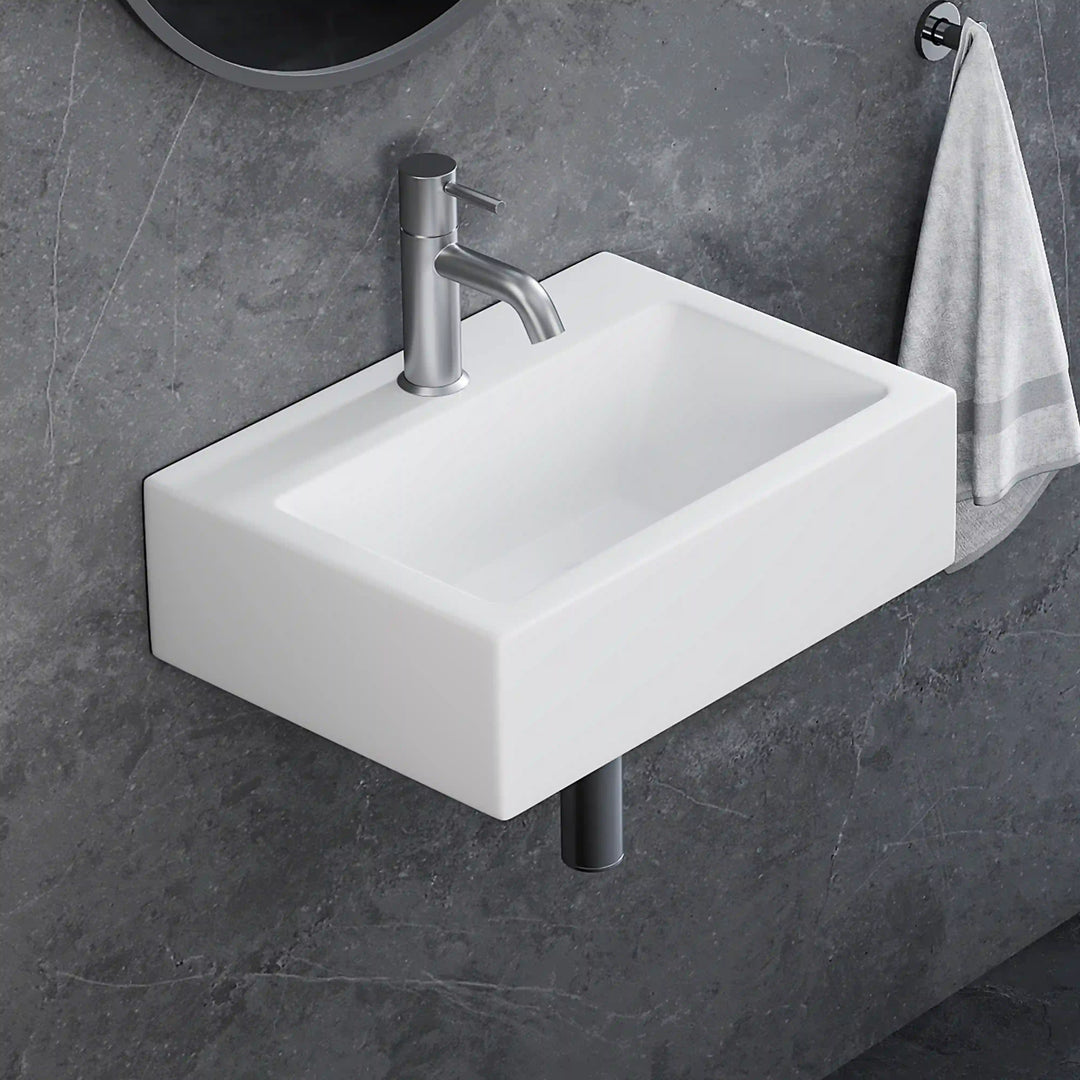 White rectangular wall-mounted ceramic sink with brushed nickel faucet