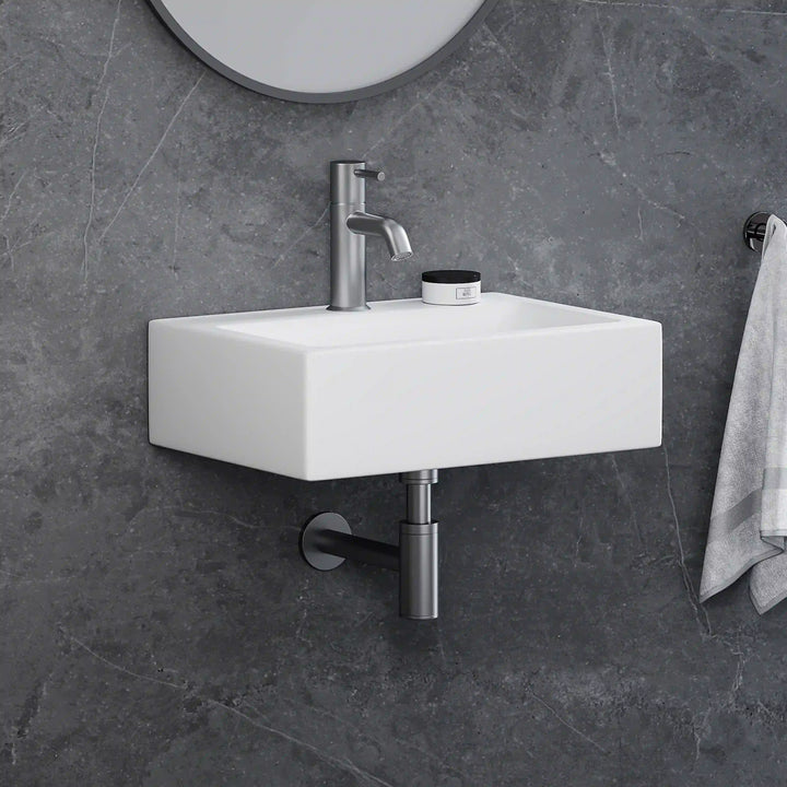 White rectangular ceramic wall-mounted sink with brushed nickel faucet