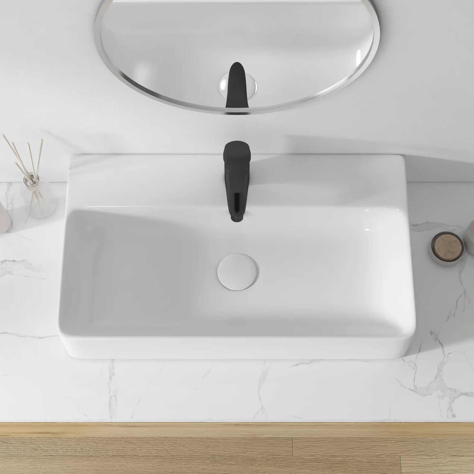 White rectangular ceramic sink with black faucet, overhead view.
