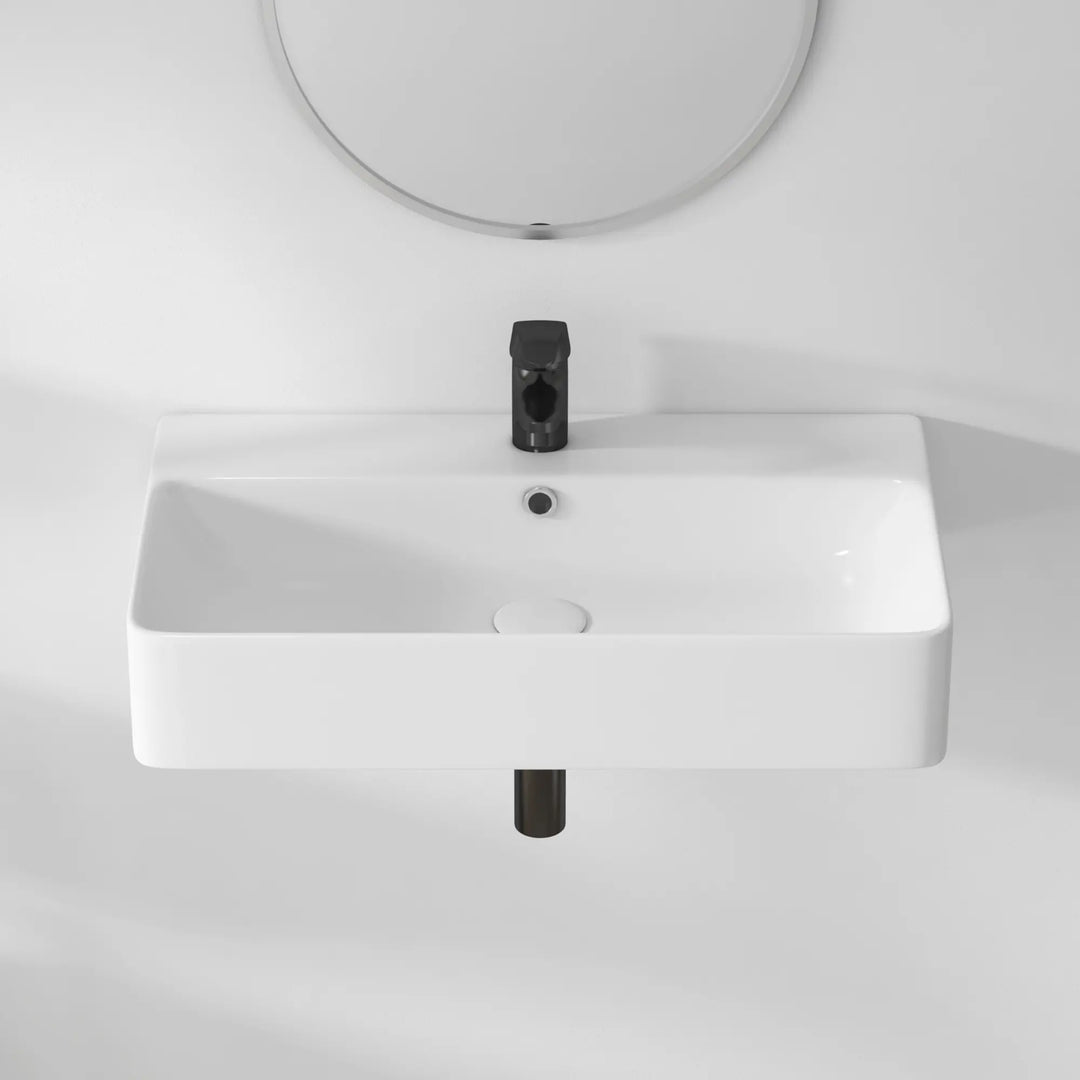 White rectangular ceramic sink with black faucet, overhead view.