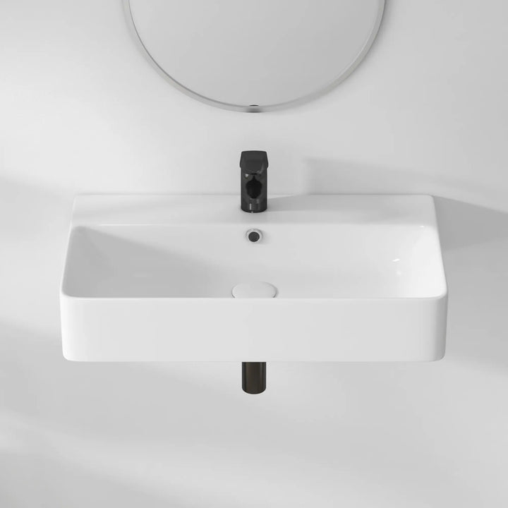 White rectangular ceramic sink with black faucet, overhead view.