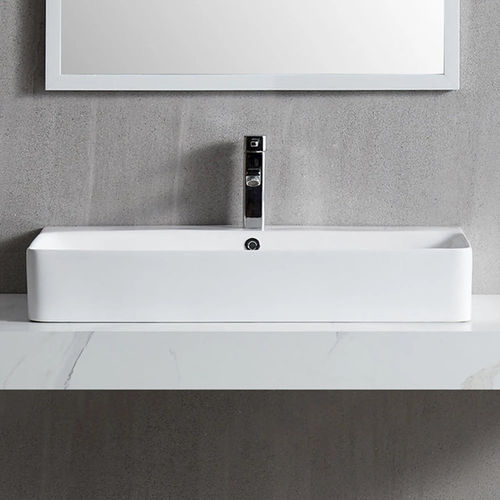 White rectangular ceramic vessel sink with chrome faucet
