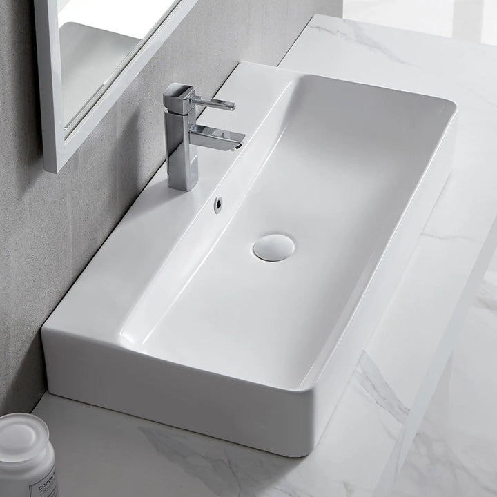 White rectangular ceramic vessel sink with chrome faucet