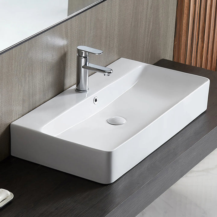 White rectangular ceramic vessel sink with chrome faucet