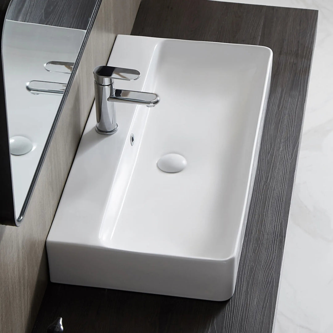 White rectangular ceramic vessel sink with chrome faucet
