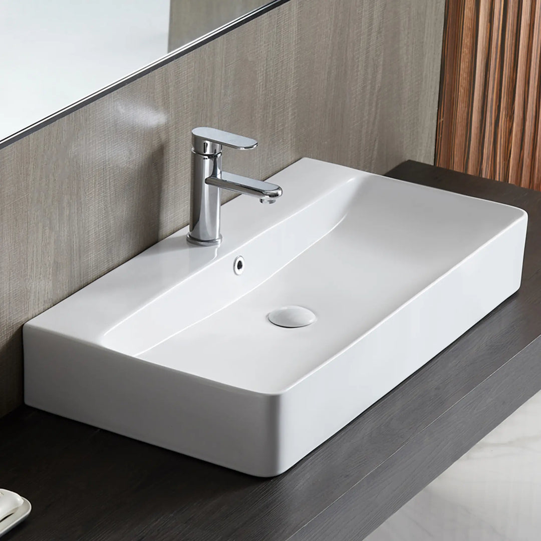 White rectangular ceramic vessel sink with chrome faucet