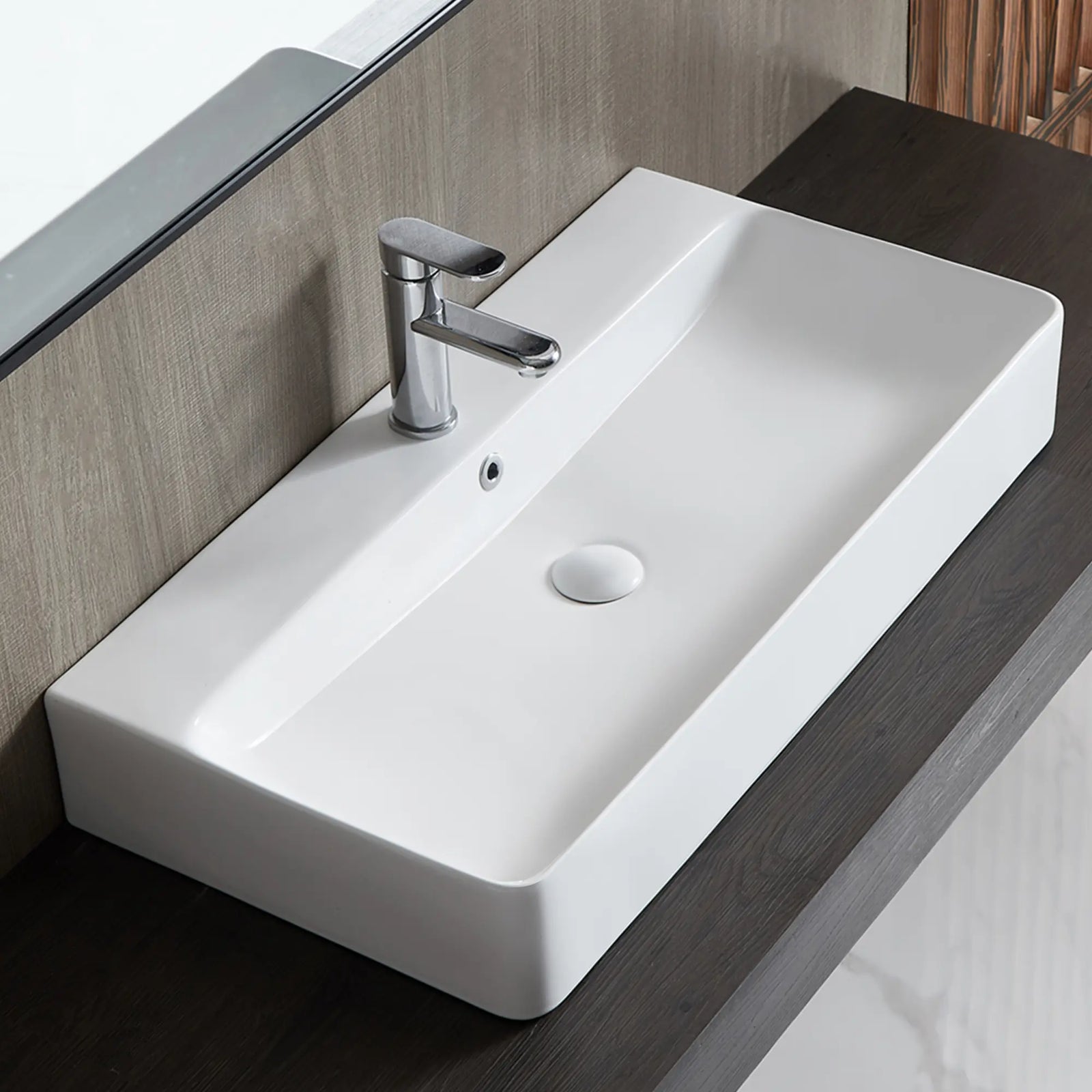 White rectangular ceramic vessel sink with chrome faucet