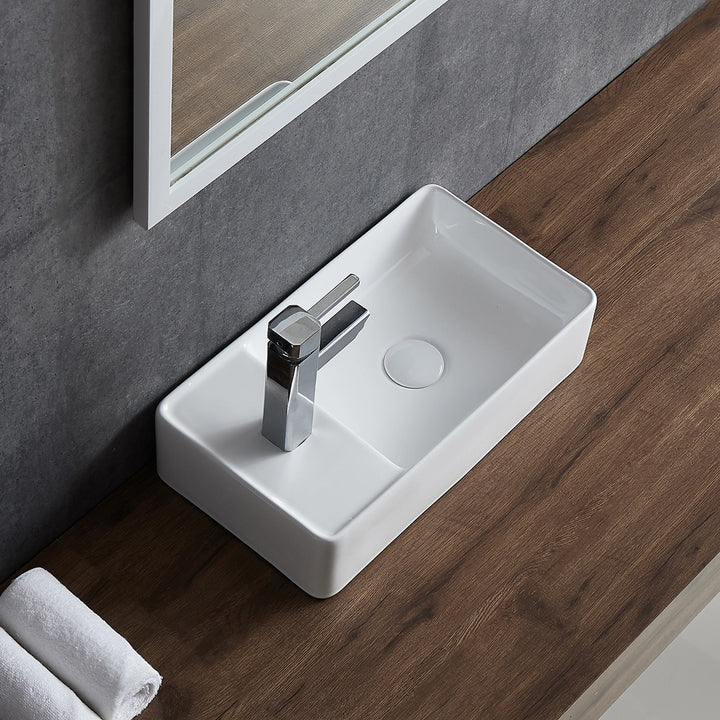 White rectangular ceramic vessel sink with side faucet hole.