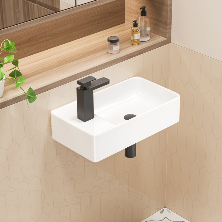 White wall-mounted rectangular ceramic sink with matte black faucet.